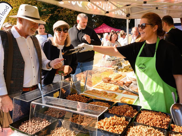 Pictured is: Ian and Debbie, visitors to the South Downs Food Festival try some of the food at Kotinas. Picture: Keith Woodland (140921-9)