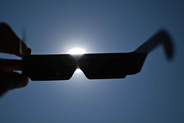 Adequate eye protection must be worn to view the eclipse safely. Picture: Gabriel BOUYS / AFP via Getty Images