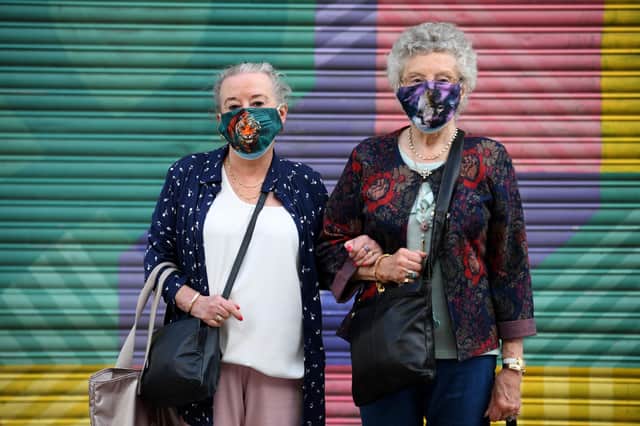 Shoppers wearing face masks pose in South Yorkshire (Photo by Oli SCARFF / AFP) (Photo by OLI SCARFF/AFP via Getty Images)