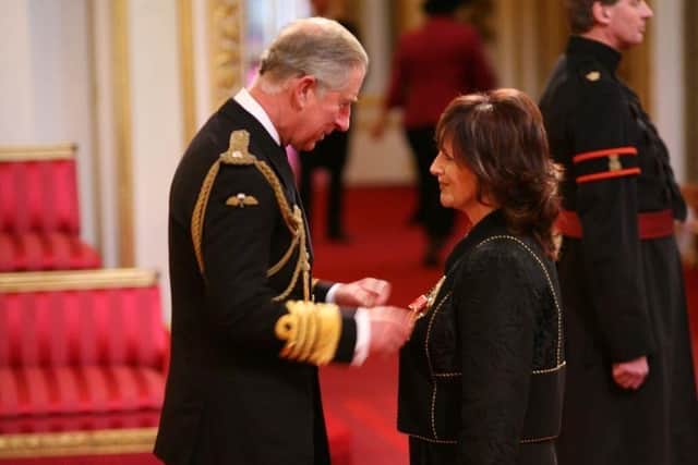 Margaret Miles-Bramwell being given her OBE