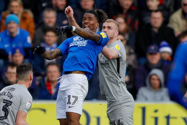 Peterborough United forward Ivan Toney battles with Pompey defender Jack Whatmough. Picture: Simon Davies