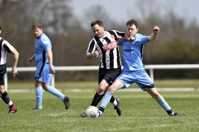Josh Watts (black/white) in action for Hayling United in the friendly against Portchester U23s at Hayling College. Picture: Allan Hutchings