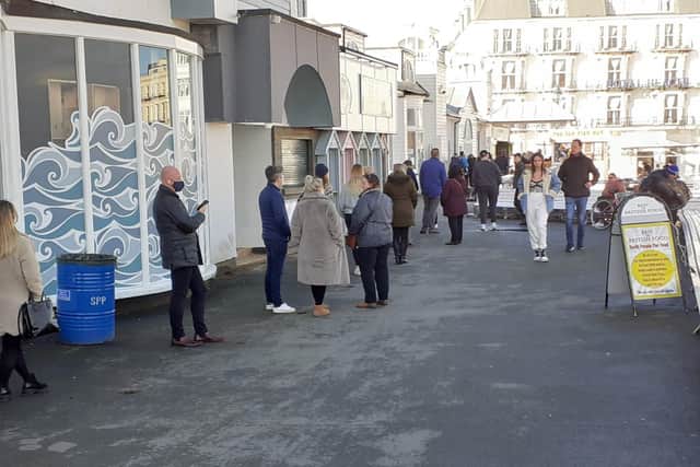 People queuing for food on South Parade Pier.