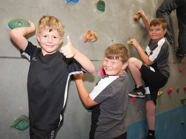 Brothers Joey, Braxton and Dalton Preston climbing on the bouldering wall.
Picture: Stuart Martin (220421-7042)