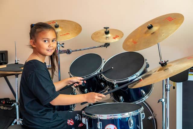 8-year old drummer Mia Mallari at home with her drum kit. Picture: Mike Cooter (060822)