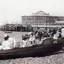Dressed for summer. Row boats for hire and gentlemen taking their girls dressed in white for a row alongside Clarence Pier