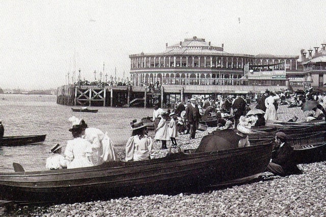 Dressed for summer. Row boats for hire and gentlemen taking their girls dressed in white for a row alongside Clarence Pier