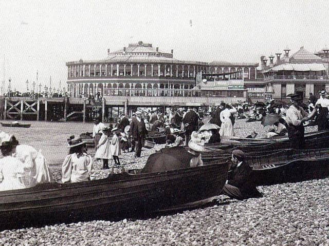 Dressed for summer. Row boats for hire and gentlemen taking their girls dressed in white for a row alongside Clarence Pier