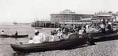 Dressed for summer. Row boats for hire and gentlemen taking their girls dressed in white for a row alongside Clarence Pier