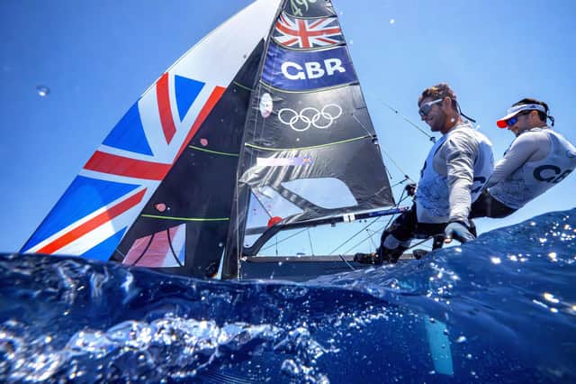 Britain's James Peters and Fynn Sterritt foil while skimming the water with their hands on their way to compete in a men's skiff race yesterday. Picture: Jacquelyn Martin