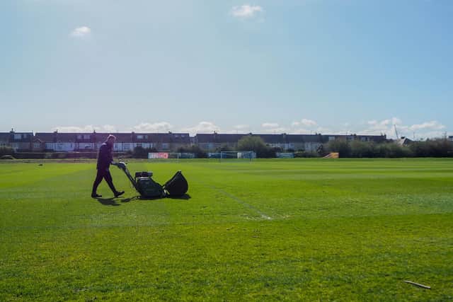 A member of the ground staff cuts the grass at Pompey's training ground.  Picture: Habibur Rahman