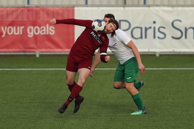 Strawberry's Frank Scott gets to the ball ahead of dangerman Harry Potter. Picture: Dave Haines.