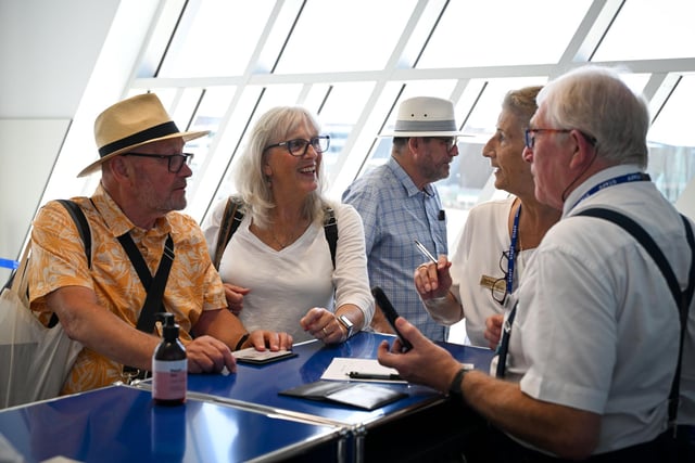 Passengers check in at the arrival desks in the new terminal