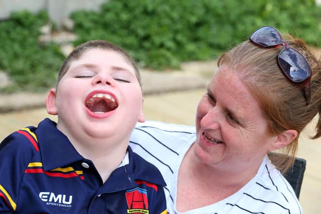 Archie Cleaver, 10, and his mother, Victoria Cleaver, have had their Paulsogrove garden made over by representatives from Propp, Glenhawk Finance, MT Finance, Together Finance and Helping Hands at Wellchild. Picture: Chris Moorhouse (jpns 040522-48)