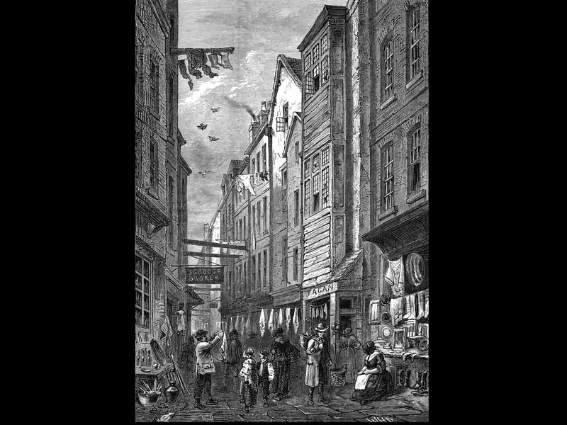 A view of Field Lane, Clerkenwell, London, circa 1840. The street was known as a centre for 'fences', or receivers of stolen property, and the area was the setting for Charles Dickens's 'Oliver Twist'. Shop signs in the engraving allude to the dickensian connection with the names 'Scrooge Broker' and 'Fagan' (over a shop selling handerchieves). (Photo by Hulton Archive/Getty Images)