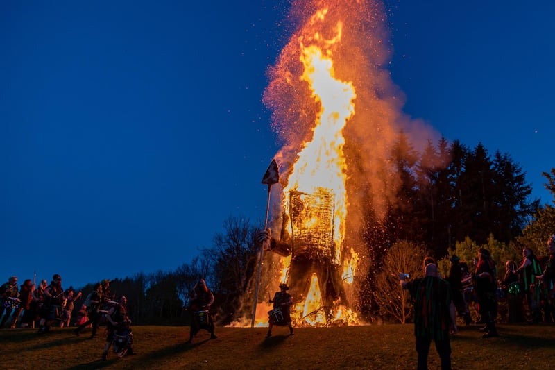 The Wicker Man fully aflame as the Pentacle Drummers perform in front of it.
