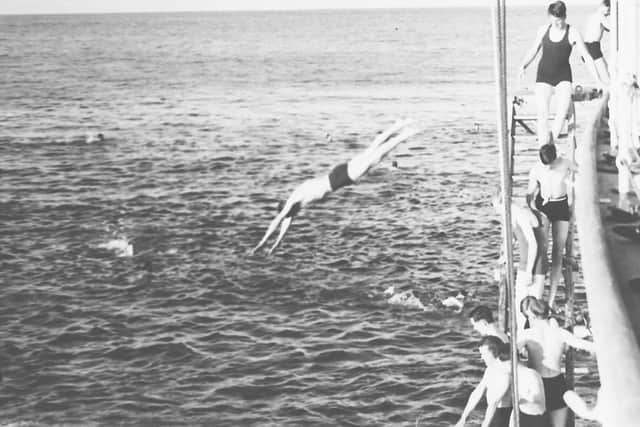 In warmer climes a ship's company would have the chance of a swim. That is a sailor on the top right in a bathing costume of the time. Picture: Andrew August collection