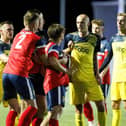 Harry Birmingham (middle of the three Moneyfields players in yellow) was sent off at New Milton during a shock Wessex League Cup exit. Picture by Dave Bodymore.