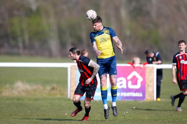 Moneyfields defender Stanlie Hopkins wins a header at Fleetlands. Picture: Dave Bodymore