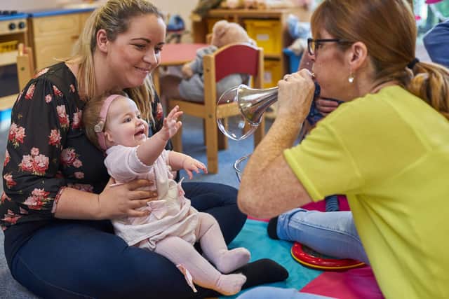 Deputy CEO Julie Hughes supporting a deaf baby and parent to develop those first, vital listening skills through music.
Picture: Elizabeth Foundation