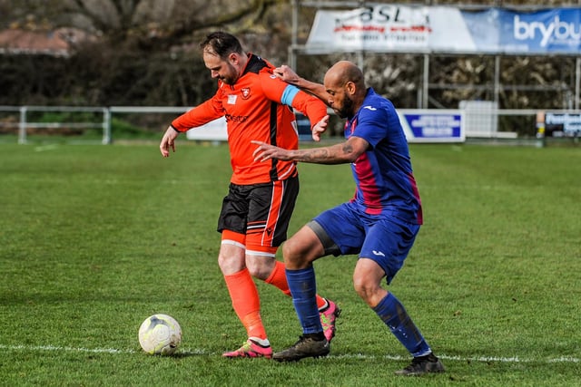 Portchester's Brett Pitman holds off USP defender Shawn Benjamin. Picture by Daniel Haswell