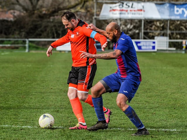 Portchester's Brett Pitman holds off USP defender Shawn Benjamin. Picture by Daniel Haswell