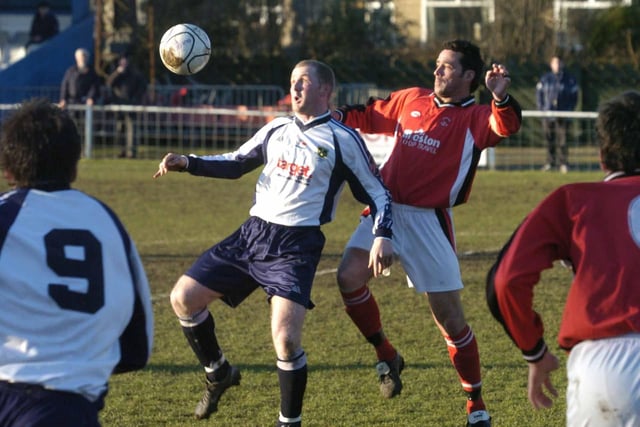 Ilkeston's Colin Hoyle (right) challenges an opponent in a match at Guiseley.