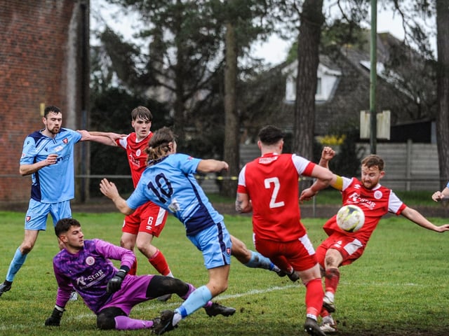 Scott Jones scores for AFC Portchester (blue) v Bournemouth Poppies. Picture by Daniel Haswell