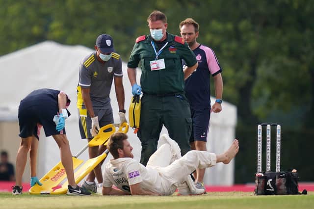 Hampshire's Liam Dawson lies in pain after picking up an injury during day two of The Bob Willis Trophy match at Radlett. Pic: John Walton