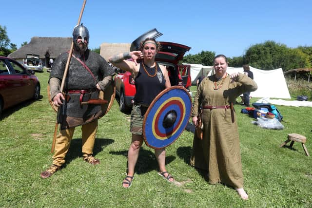 Butser Ancient Farm event sadly cancelled due to a burst water main in the local area. Pictured are Jen Atkinson, (with shield) Tom Tribe and Danielle James packing up to leave the site in the heat.Picture: Sam Stephenson