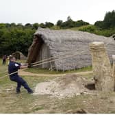 Crew members from HMS Queen Elizabeth and volunteers help raise a 3.5 ton standing stone, using only traditional methods, at Butser Ancient Farm to mark its 50 year anniversary