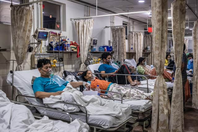 NEW DELHI, INDIA - MAY 03: Patients who contracted the coronavirus lie in beds while connected to oxygen supplies inside the emergency ward of a Covid-19 hospital on May 03, 2021 in New Delhi, India. India recorded more than 360,000 coronavirus cases in a day for the 12th day in a row as the total number of those infected according to Health Ministry data neared 20 million. The real figure could be up to ten times higher, many health experts say, due to a lack of widespread testing or reporting, and only patients who succumbed in hospitals being counted. A new wave of the pandemic has totally overwhelmed the country's healthcare services and has caused crematoriums to operate day and night as the number of victims continues to spiral out of control. (Photo by Rebecca Conway/Getty Images) ***BESTPIX***