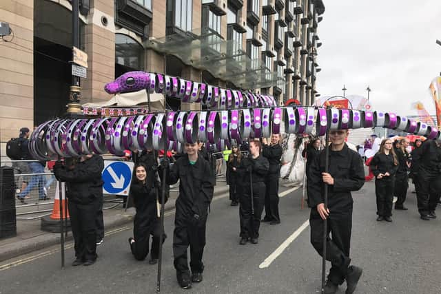 Gosport students perform in front of The Queen at the Platinum Jubilee Pageant by carrying wolfhound and snake. Picture: Tom Barnes.