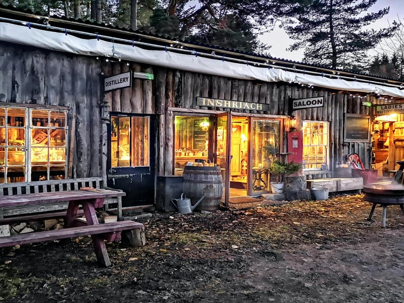 The 2015 winner, built by Walter Micklethwait
A few years ago this was a dilapidated hen house and an assorted pile of old junk. Now, after some very sporadic work it has become the Inshriach Farm shop, Ladies waiting room, Saloon Bar and Distillery. The General stores is a shop selling items we have carved or whittled on the farm and eggs and produce from the gardens. The ladies waiting room is a cheeky recycled velour upholstered piano bar and the saloon is a dirty wild west gin joint. In an unexpected twist to the shed tale, word got out that the bar was coming together and that we had juniper growing on the farm and before we knew it the shed became home to its very own gin distillery, complete with a lovely hand hammered set of stills from Portugal and its own all Scottish gin brand, Crossbill
