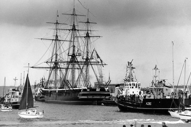 HMS Warrior. Mid-19th Century masts dominate the 20th Century harbour scene as the long voyage draws to a close in June 1987. The News PP5412