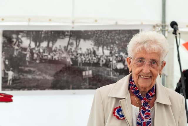 Irene Kingham, 90, in front of her picture from 1945, which includes her mother in law and sister in law. Picture: Mike Cooter (210821)