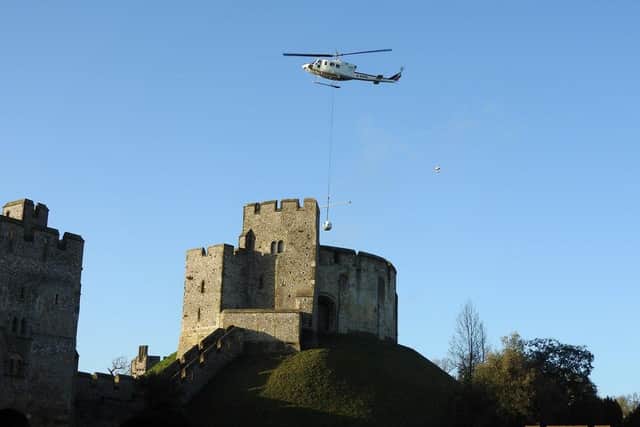 A helicopter takes soil from Arundel Castle's Keep.