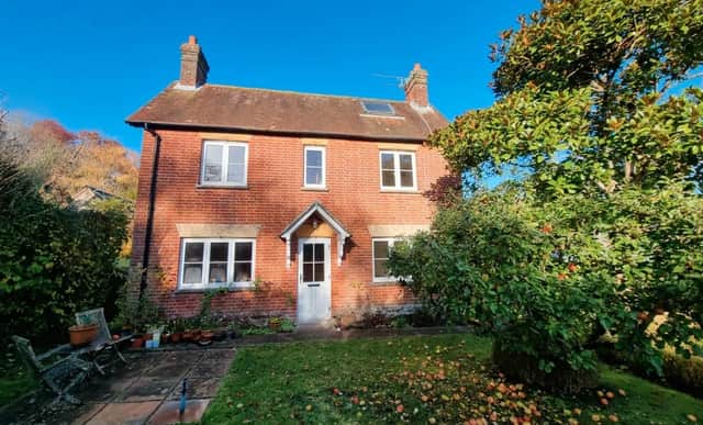 The listing says: "Myrtle Cottage is located set back from the central square in the rural quintessential Hampshire village, where development is rare. This symmetrical fronted cottage has a central front door with sitting room to one side and dining room to the other which then leads into the kitchen at the rear of the property."
