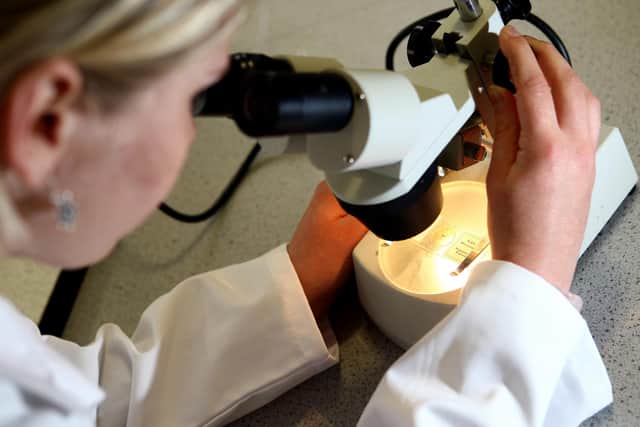 A student looks a matter under a microscope. May 2008.PA Photo : David Davies.