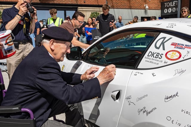 D-Day veteran Cyril Stanley (Stan) Ford adds his signature to the Ferrari 812 Superfast during the Guinness World record attempt. 
Picture: Mike Cooter (290723)