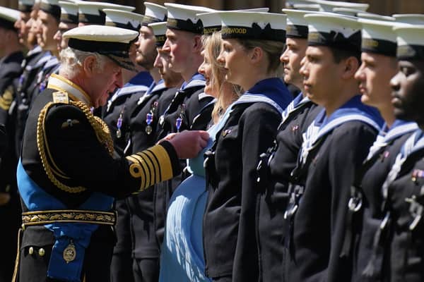 King Charles III presents seven-month pregnant Medical Assistant Paisley Chambers-Smith with the Royal Victorian Order to members of the Royal Navy for their part in Queen Elizabeth II's funeral procession, on the Quadrangle at Windsor Castle on May 30, 2023 in Windsor, England. Photo by Jonathan Brady-WPA Pool/Getty Images