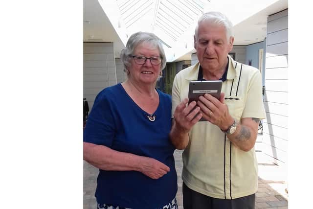 Patricia and Roy Crooks using one of the tablets to video call their loved ones. Picture: Supplied