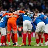 Pompey players in a huddle after their brave Spurs display. (Photo by IAN KINGTON/AFP via Getty Images)
