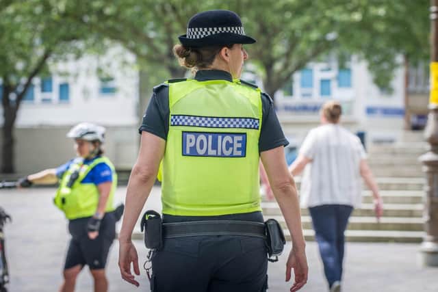 A man has been arrested for a string of shoplifting offences. Pictured is a police officer in Guildhall Square, Portsmouth.