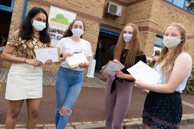 Masked up: Students Anina Sebastian, left, with Calliope Wellbelove, Laura Vahey, Eleanor Andrew pick up their grades.
Picture: Duncan Shepherd