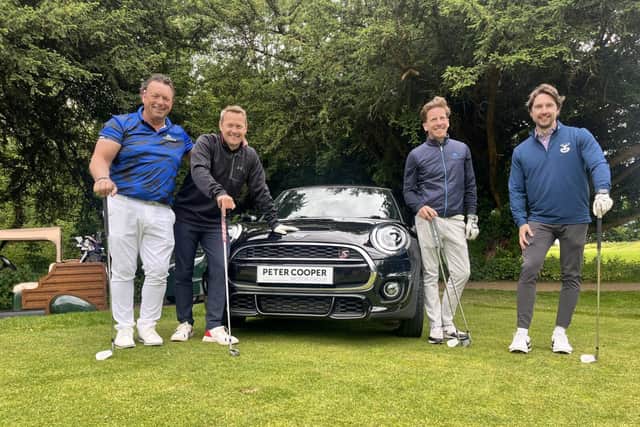 Darren Cooper with golfers at charity event