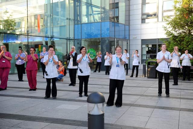 NHS workers at Queen Alexandra Hospital braved the Covid pandemic to help save countless lives. Here they are pictured during the Clap for Carers event in May 2020. Picture: Sarah Standing (280520-9091)