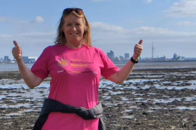 Adele was diagnosed with a brain tumour following an impromptu eye test in Portsmouth nearly a decade ago. Pictured: Adele in her Brain Tumour Research t-shirt with Spinnaker Tower in the background