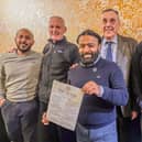 From left to right, Faz Ahmed, Mick Mellows, Jaf Ahmed, John Milkins and Executive Chair of the Pompey History Society Mick Comben. Jaf is holding the Pompey-themed menu for the curry night at the Akash.