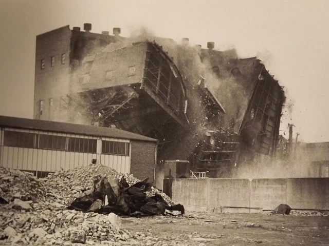Portsmouth power station coming down. After the power station chimneys had been brought down brick by brick the main structure was brought down by explosives 1983.